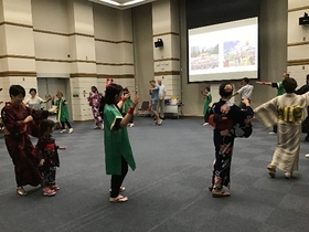 Participants dancing with the volunteers after learning the dance moves