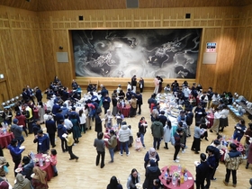 Millennium Hall filled with faculty, staff, students and guests socializing